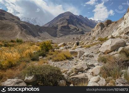 Landscape view of wilderness area in Passu trekking trail surrounded by mountains. Gojal Upper Hunza. Gilgit Baltistan, Pakistan.