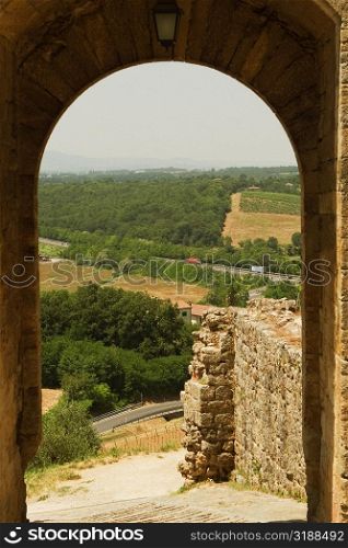 Landscape viewed through an archway, Porta Franca, Monteriggioni, Siena Province, Tuscany, Italy