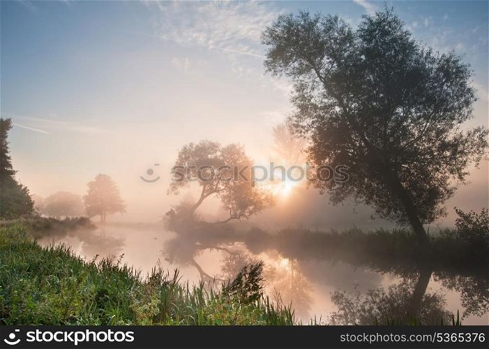 Landscape viiew across foggy river at sunrise