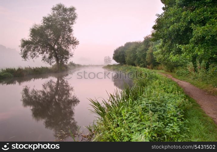 Landscape viiew across foggy river at sunrise