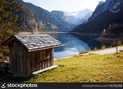 landscape with a beautiful mountain lake with reflection. Autumn. beautiful landscape. wooden house in the foreground