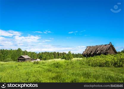 Landscape with a dead village Burdovo on a summer day, Kostroma oblast, Russia.
