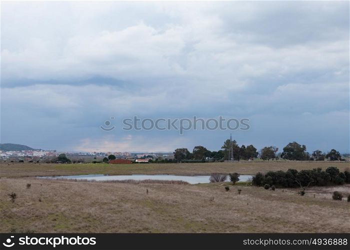 Landscape with a lake and a cloudy sky