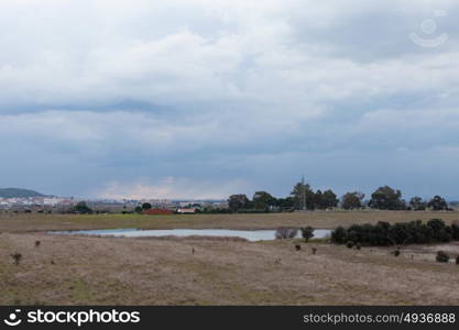 Landscape with a lake and a cloudy sky