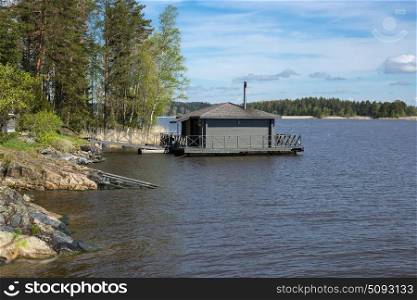 Landscape with a lodge on the lake in Karelia