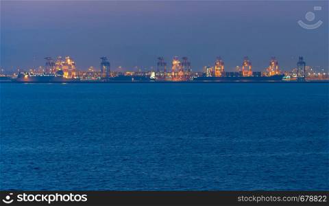 Landscape with a sea and industrial port at twilight. Barcelona, Spain