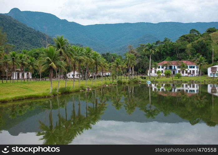 landscape with abandoned mansion and palm trees at Brazil