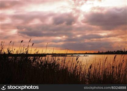 Landscape with beautiful sunset sky over the lake