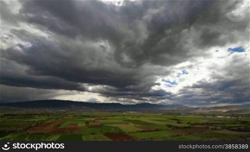 Landscape with fast moving clouds, time-lapse, day