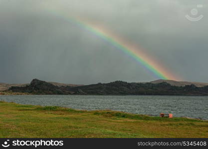 Landscape with forest lake and rainbow. lake and rainbow