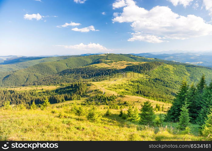 Landscape with green sunny hills with blue sky and clouds. Landscape with green sunny hills