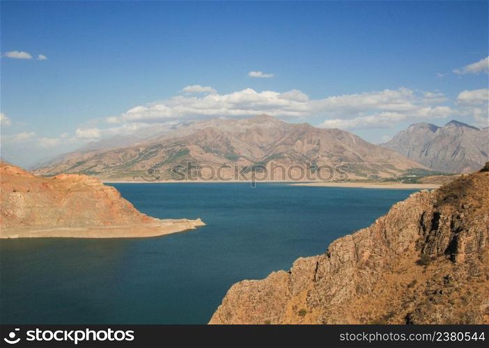 landscape with lake and mountain views. Uzbekistan, Charvak reservoir. Nature of Central Asia. landscape with mountains