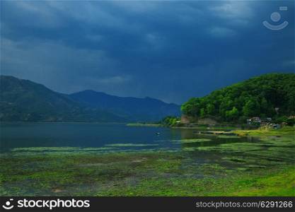 Landscape with lake and mountains before the storm. Pokhara, Nepal