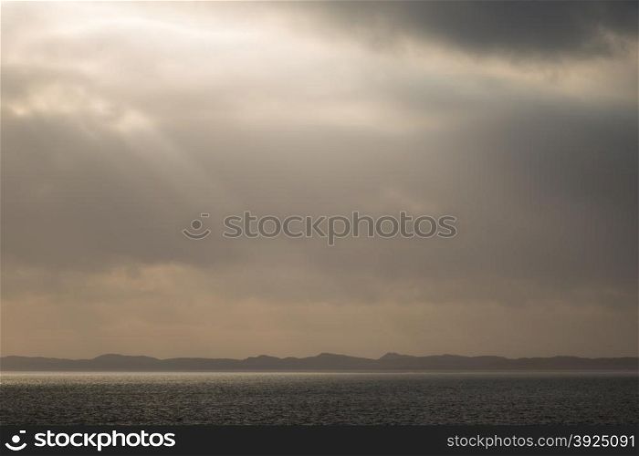 Landscape with ocean and sun light, fog and clouds