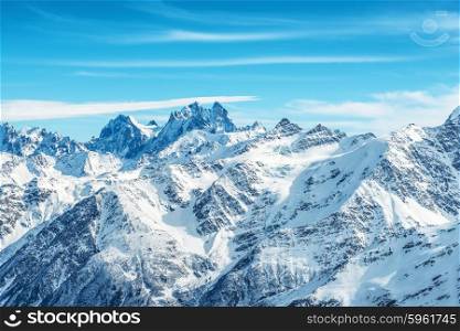 Landscape with snow in blue mountains over sky and clouds