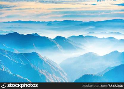 Landscape with sunset in blue mountains. Landscape with sunset in blue mountains and fog