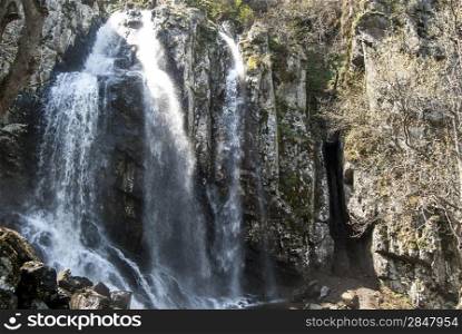 Landscape with vernal waterfall in sunny day