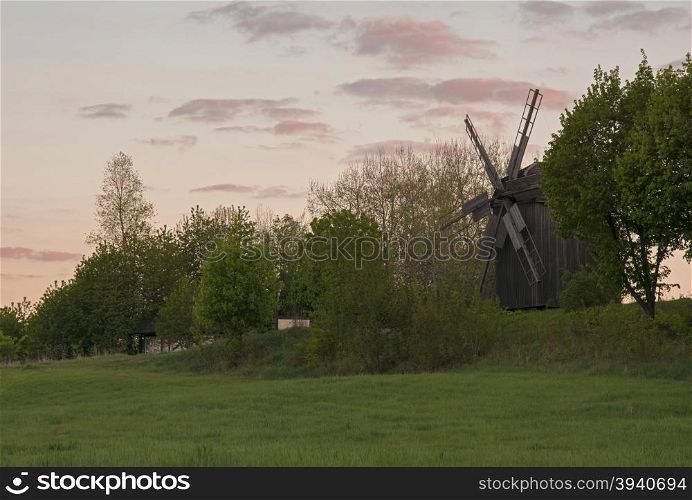 landscape wooden windmill at sunset in the village
