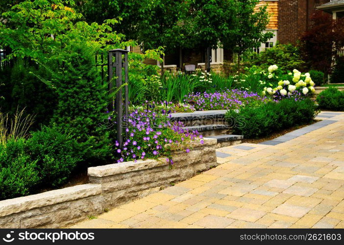 Landscaped garden and stone paved driveway