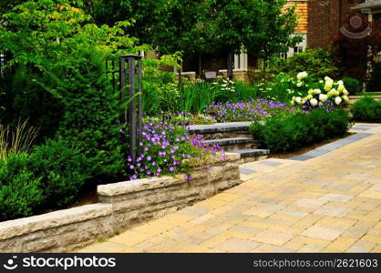 Landscaped garden and stone paved driveway