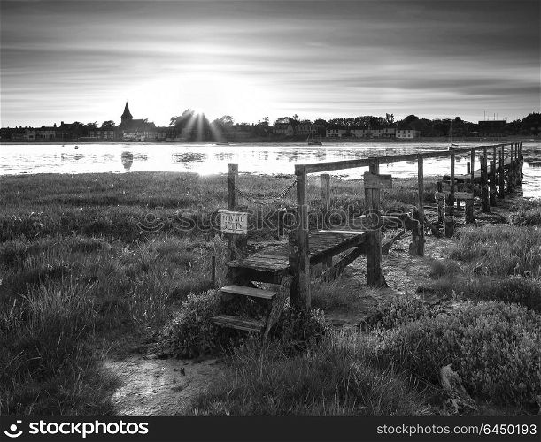 Landscapes. Black and white low tide landscape of Bosham Harbour with private jetty.