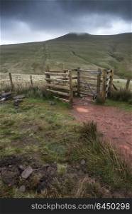Landscapes. Footpath in Brecon Beacons landscape leading to Corn Du peak with stormy sky overhead