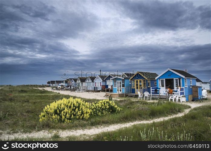 Landscapes. Landscape of dramatic stormy sky over beach huts in grassy dunes