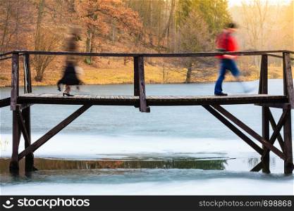 Landscapes, objects, beauty of nature concept. Old, wooden, small bridge on frozen lake, sunny chilly day.. Old, wooden, small bridge on frozen lake
