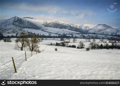 Landscapes. Snow covered Winter landscape at sunrise in Peak District in England