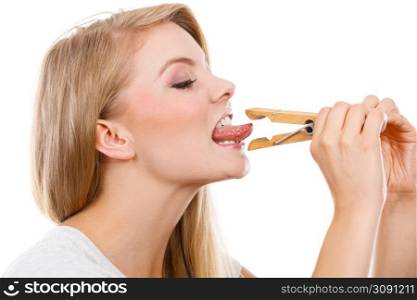 Language barrier, rumors, problems with expressing concept. Blonde woman having tongue in clothespin. Blonde woman having tongue in clothespin