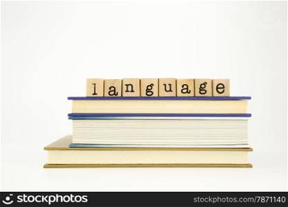 language word on wood stamps stack on books, academic and study concept