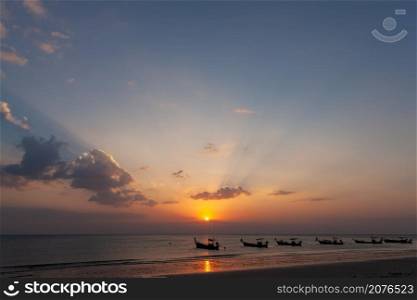 Lanscape of longtail boat in evening time with sunray beam at the beach, Phang Nga, Thailand