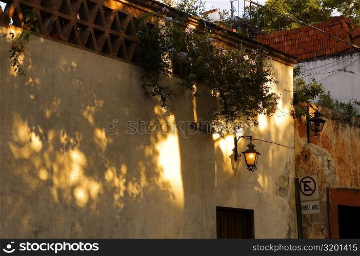 Lantern lit up on the wall of a building, Mexico