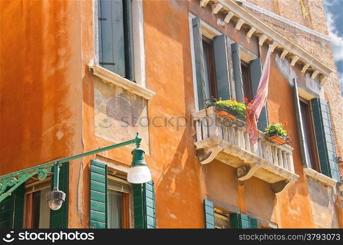 Lantern on a facade of picturesque houses in Venice, Italy