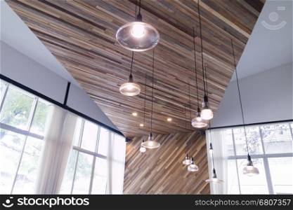 lantern on skew wooden wall with white curtain