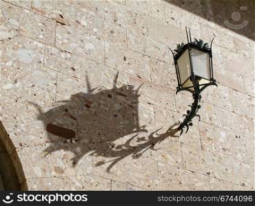 lantern on wall. lantern and its shadow on a wall, interesting structure