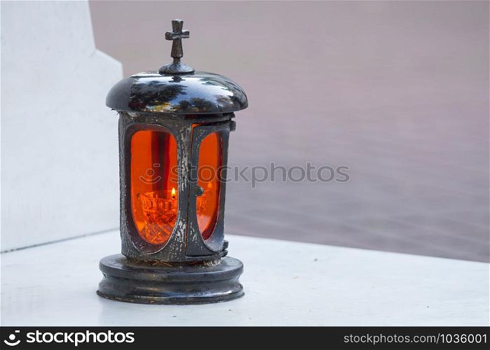 Lantern with a candle in the cemetery