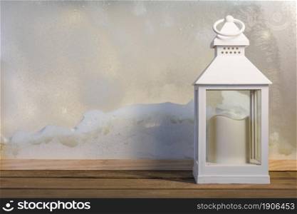 lantern with candle wooden board near heap snow through window. High resolution photo. lantern with candle wooden board near heap snow through window. High quality photo