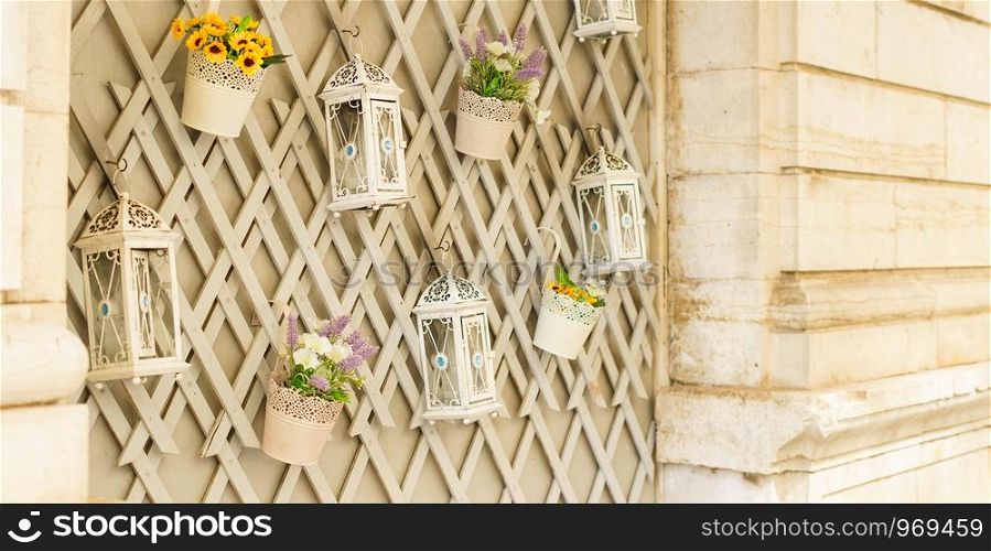 Lanterns lamps and flowers wall decoration on the facade of the old building in Corfu town greece