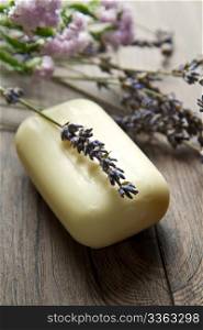 lanvander soap with flower on wooden background