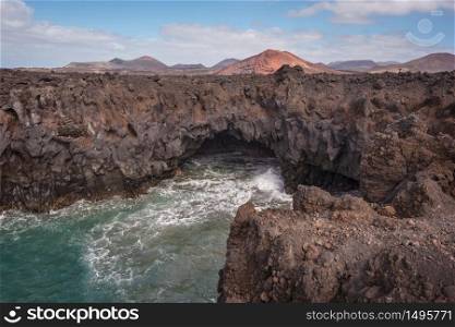 Lanzarote landscape. Los Hervideros coastline, lava caves, cliffs and wavy ocean. No people appears in the scene.