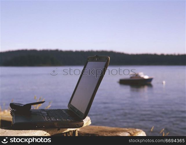 Laptop and Cell Phone by the Lake