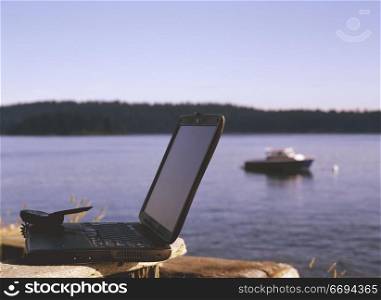 Laptop and Cell Phone by the Lake