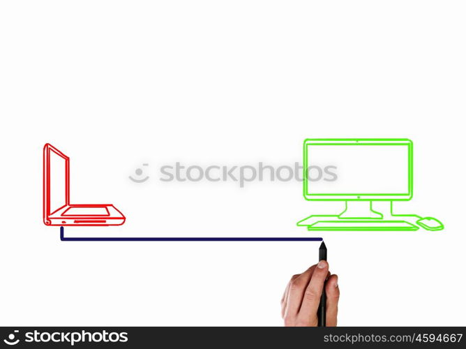 Laptop and computer connection. Close up of male hand drawing connection between laptop and computer