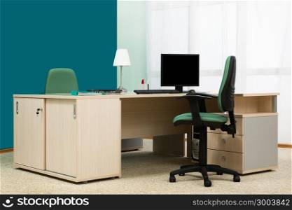 laptop and computer on a desk in a modern office