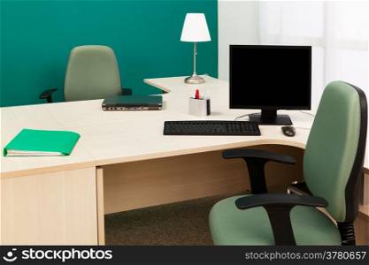 laptop and computer on a desk in a modern office