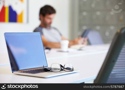 Laptop And Glasses On Desk In Design Studio