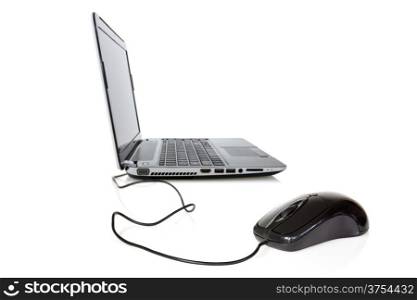 Laptop and mouse with selective focus on mouse. Isolated over a white background