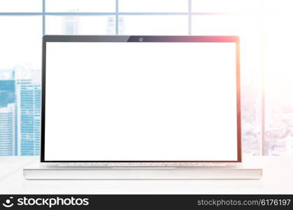 laptop at sunrise office. modern laptop with blank screen on office desk at sunrise