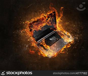 Laptop burning with fire. Concept of electronics break with device in fire flames